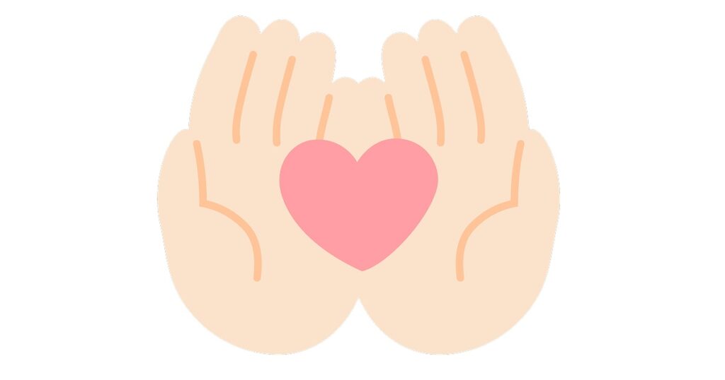 思いやりを表してハートを両手で抱えているイラスト